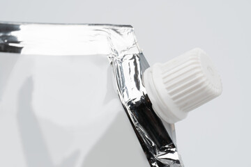 Blank spout pouch with cap or doy pack. Front view of blank glossy white doypack with cap or stand-up pouch isolated on white background.