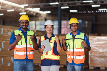 Warehouse worker asian male and female working together in import export storehouse.