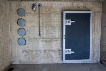 Entrance Door to a Bunker in a Sunny Day in Arzo, Ticino, Switzerland.