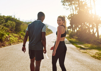 My guy makes the best workout buddy. Shot of a fit young couple slowing down for a walk during their run outdoors. © Donson/peopleimages.com