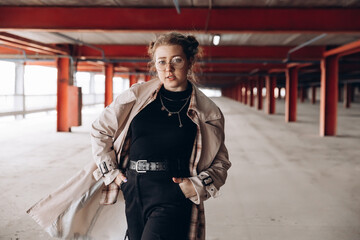 portrait of a young hipster girl in a multi-level parking