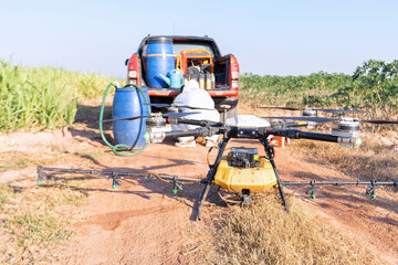 Farmer stop fly drone at ground to replace empty battery at the rice field hi technology agriculture