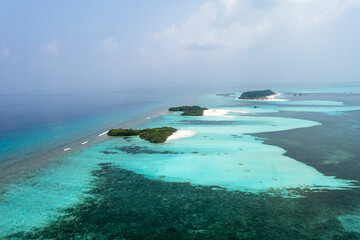Naklejka na ściany i meble Aerial view: lonely Island with a sandbank and Palmtrees in the Maldives, North Male Atoll, Maldives , Asia