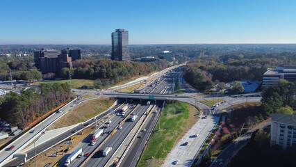 Busy traffic on Highway I-285 (the Perimeter) with construction sites, midtown Atlanta buildings...