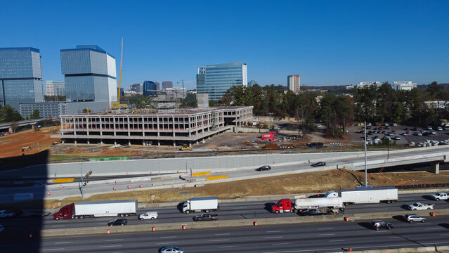 Large construction sites of high-rise office buildings and highway along Interstate 285 (the Perimeter) and Ashford Dunwoody road in midtown Atlanta, Georgia, USA