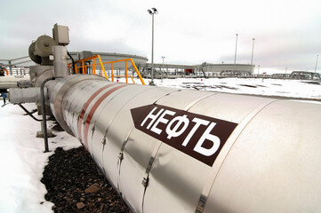 Large oil pipe in an oil field. Translation of the inscription: Oil.