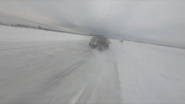 drift on a frozen lake in winter on ice and snow colorful beautiful cars drive sideways competitions, vaz bmw mercedes, flight on an FPV drone behind the car