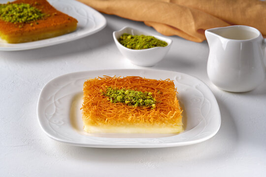 Middle eastern sweets kunefe, kunafa, kadayif with pistachio .Turkish , arabic traditional dessert.