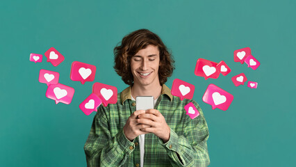 Glad millennial caucasian male student has romantic chat with hearts on smartphone enjoys message,...