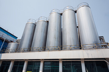 Stainless vertical steel tanks with equipment tank chemical cellar at the with stainless steel silo