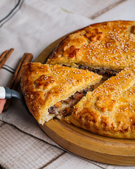 Closeup on sliced baked pie with beef and pumpkin filling