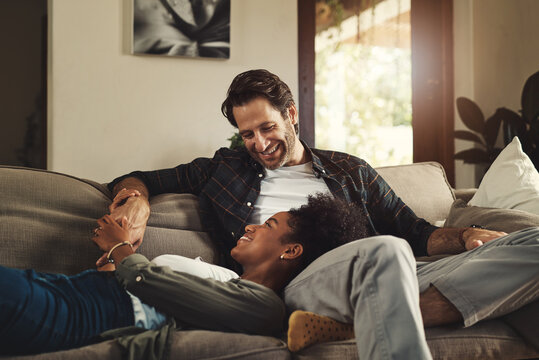 He satisfies my soul. Shot of a happy young couple relaxing on a sofa and spending time together at home.