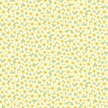 Seamless pattern of abstract yellow narcissus flowers on a green background.
