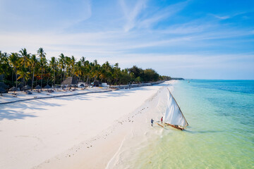 Behold the breathtaking aerial footage of Zanzibar's Kiwengwa beach, a tropical paradise with swaying palms and crystal-clear waters