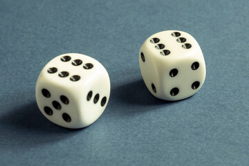 Random number generator. Two white dice with numerical values lie in a chaotic order.