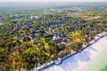 This stunning toned aerial view captures the beauty of Kiwengwa beach in Zanzibar, Tanzania. The luxurious resort and the turquoise ocean water create a picture-perfect scene.