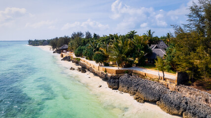 This stunning toned aerial view captures the beauty of Kiwengwa beach in Zanzibar, Tanzania. The luxurious resort and the turquoise ocean water create a picture-perfect scene.