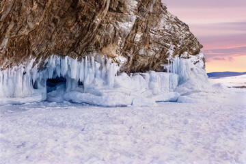 Ice grottoes and icicles on the winter lake Baikal