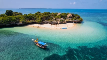 Papier Peint photo Lavable Zanzibar Board a traditional wooden dhow boat and discover the natural wonders of Zanzibar's Blue Safari, from coral reefs to deserted islands.