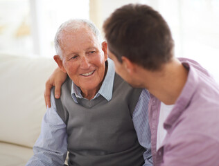 So grateful for his wisdom. Shot of a senior father bonding with his son in their living room.