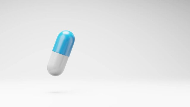 One Blue and White Pill Spinning on a Studio Light Gray Background, Seamless Loop 3D Animation with Copy Space