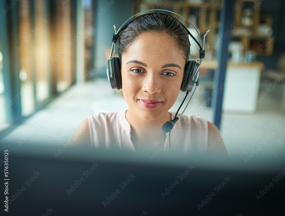 Poster please hold while i connect your call. shot of a young woman working in a call center.