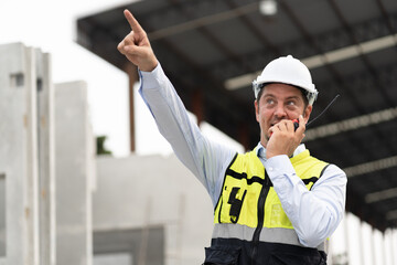 Caucasian engineer man use walkie talkie at precast site work