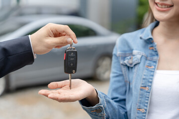 lease, rental car, sell, buy. Dealership manager send car keys to the new owner.  Sales, loan...