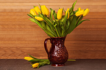 Spring tulips in a bouquet in a ceramic jug