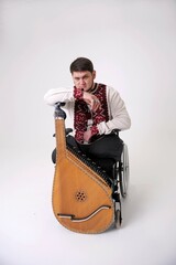 Ukrainian Cossack leaned on bandura musician on a white background in a wheelchair beautiful music...