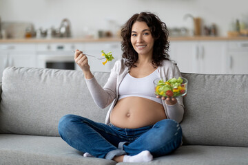 Happy Young Pregnant Lady Eating Fresh Vegetable Salad At Home - obrazy, fototapety, plakaty
