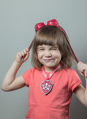 A smiling girl in pink aviator glasses. The character Sky from the animated series Puppy Patrol.