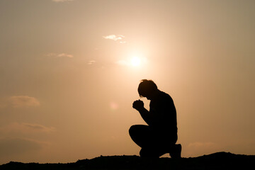 Fototapeta na wymiar Silhouette of man praying for god's blessing. hope concept