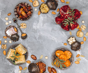 Ramadan composition of traditional Islamic dishes, dried fruits, fresh garnet and tea. Copy space, top view.
