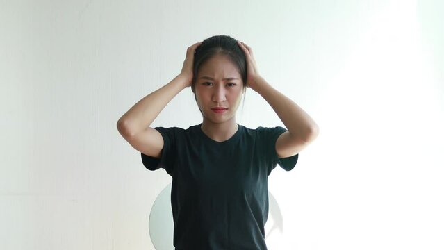 Stressed woman holding her temples with severe problems in her life, Family problems, Pressure from work, Poor financial, Despair in life, Discouraged and deeply saddened, Panic attacks.