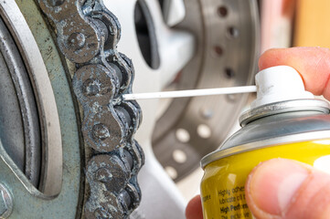 Motorcycle drive chain, and lubricant spray.
