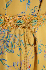 clothing detail, yellow fabric with a blue geometric pattern
