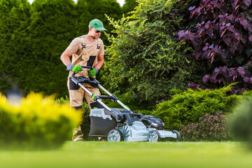Gardener Performing Lawn Maintenance Using Power Mower - obrazy, fototapety, plakaty
