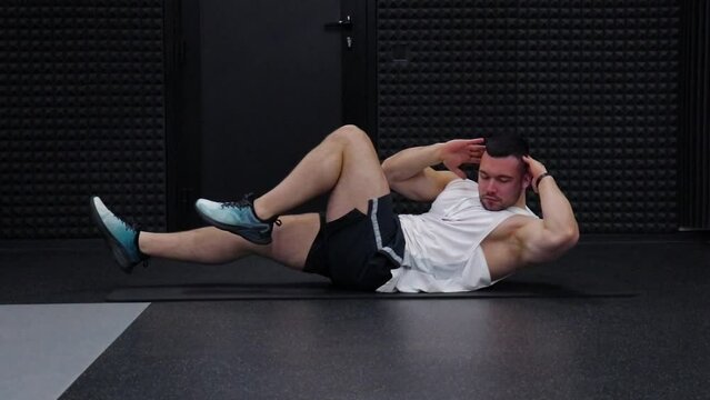 man training abdominal muscles in a fitness club	