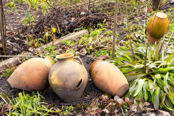 Broken earthenware jugs lie on the ground. Village still life.