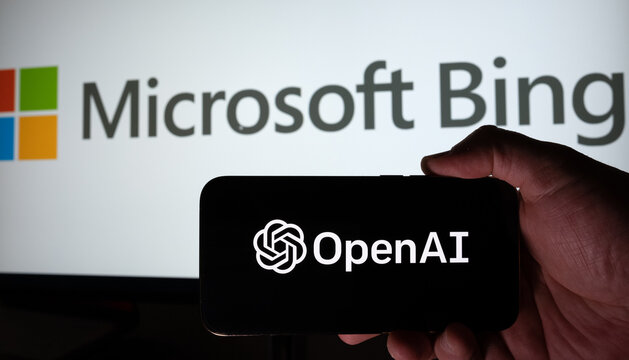 OPENAI Logo Seen On Smartphone Hold in A Hand And Pc Display With MICROSOFT Bing logo On The Background. Istanbul, TURKEY- February 28, 2023.