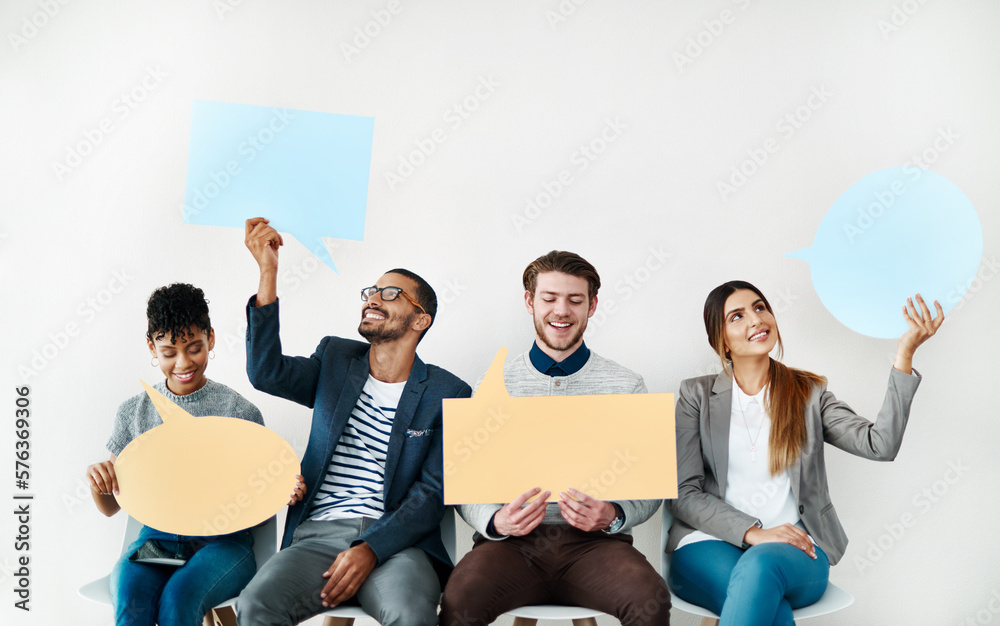 Sticker sharing our opinions. shot of a diverse group of creative employees holding up speech bubbles inside