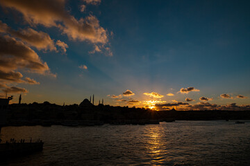 Silhoeutte of Istanbul at sunset with dramatic clouds and sunrays