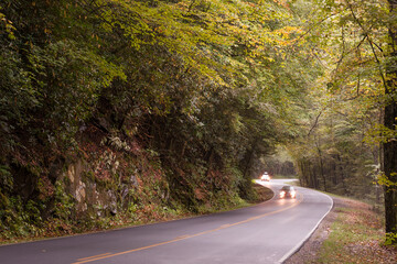Cars with lights on driving through picturesque Great Smoky Mountains national park, Tennessee, USA - 576371935