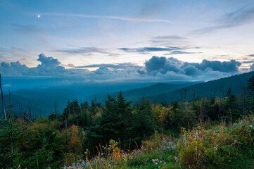 Moon and flowing clouds over ridge of Great Smoky Mountains national park at dusk, Tennessee, USA