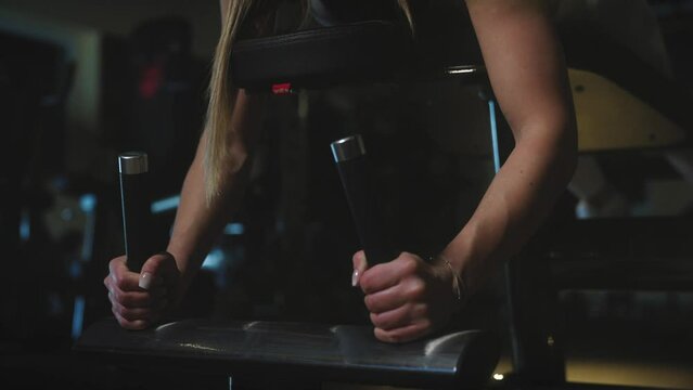 fit girl at gym holding on thight with her hands