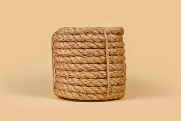 Thick woven jute rope basket on beige background