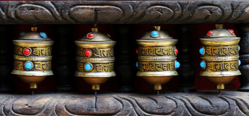 Buddhist prayer wheels in Nepal. Prayer wheels are spun by devotees to aid for meditation and...