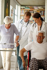 Fototapeta premium Seniors on the move... with some assistance that is. Shot of a team of doctors assisting their senior patients with physical impairments.