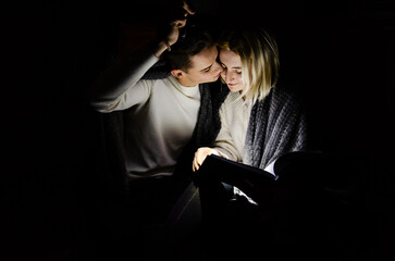 A couple in love at home during a power outage. Blackout, no electricity